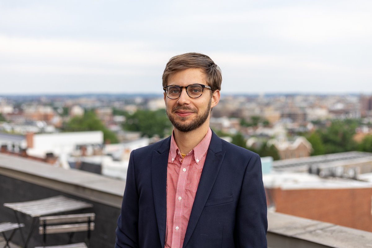 Portrait of a man on a rooftop, city in the background